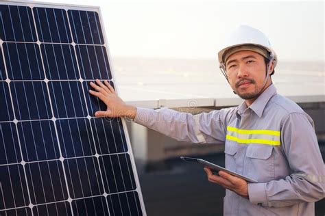 Engineer Solar Photovoltaic Panels Station Checks With Tablet Computer