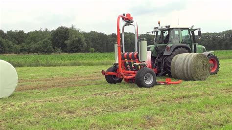 Kuhn Rw 1800 C Autoload And Autoswitch Round Bale Wrappers In Action