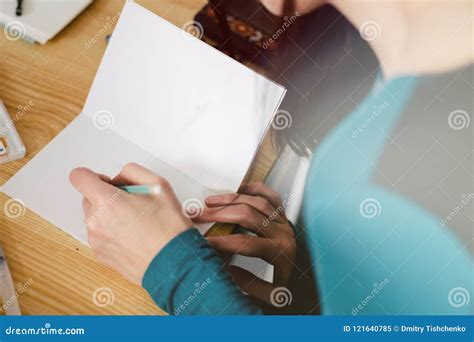 Close Up Of Female Hands Making Notes In The Notepad At Office Light