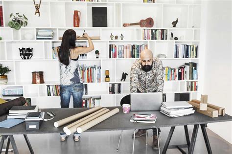 Male And Female Architects Working At Home Office Stock Photo