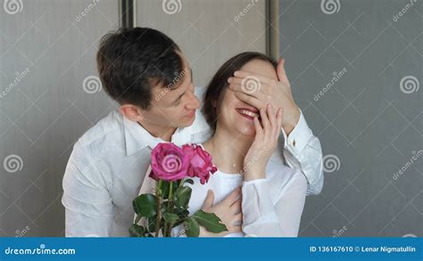 Man Closes His Is Girlfriend`s Eyes To Make Surprise And Gives Roses Stock Footage Video Of