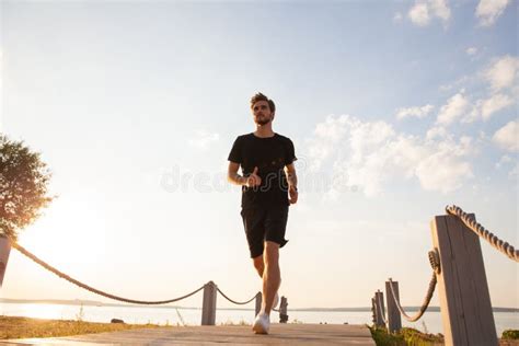 Full Length Shot Of Healthy Young Man Running On The Promenade Male