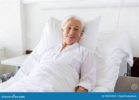 Smiling Senior Woman Lying On Bed At Hospital Ward Stock Image Image Of Pensioner Cheerful