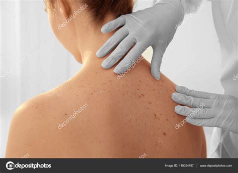 Dermatologist Examining Patient In Clinic Closeup — Stock Photo © Belchonock 148324187