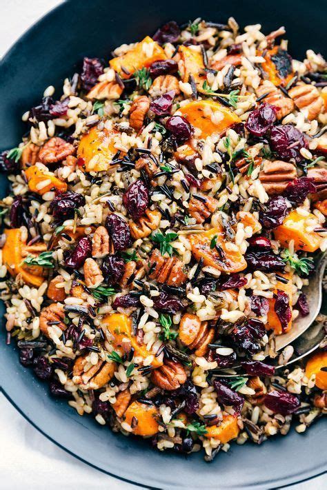 A Bowl Filled With Rice Carrots And Raisins