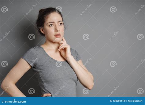 Thoughtful Young Woman With Concerned Look On Her Face Stock Photo