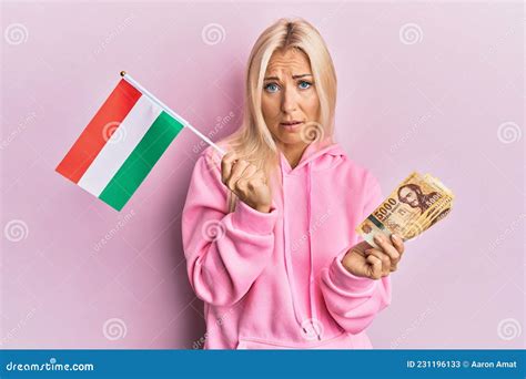 Young Blonde Woman Holding Hungary Flag And Forint Banknotes Clueless
