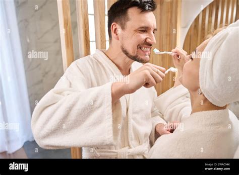 Cheerful Newlyweds Doing Their Morning Routine In The Bathroom Stock