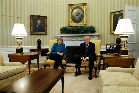in first trump merkel meeting awkward body language and a quip