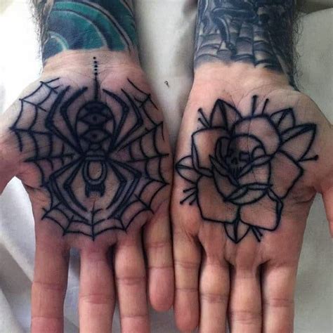 Two Hands That Have Tattoos On Them With Flowers And Spider Webs In The