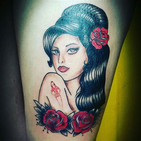 A Woman With Long Hair And Flowers On Her Thigh Is Depicted In This Tattoo Design