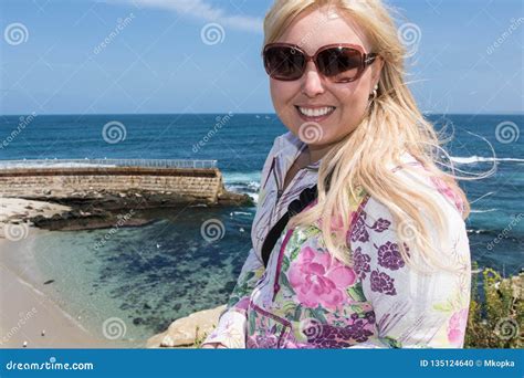 Blonde Female Explores The Rugged Rocky Beach Of La Jolla California