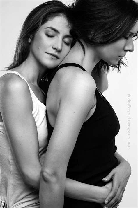 Two Women Embracing Each Other In Black And White