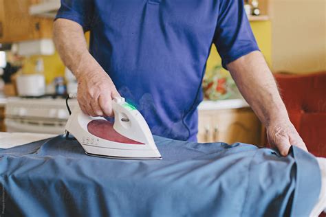 Elderly Man Ironing Clothes By Stocksy Contributor Preappy Stocksy