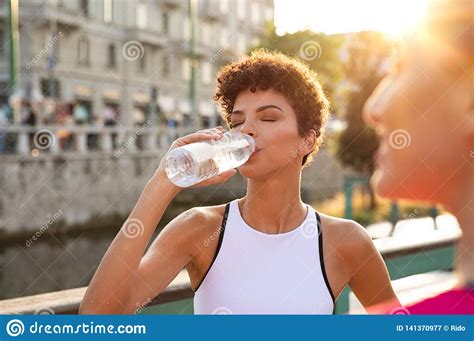 Athletic Woman Drinking Water After Workout Stock Image