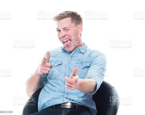 Man Seated Doing Finger Gun Stock Photo Download Image Now 20 29