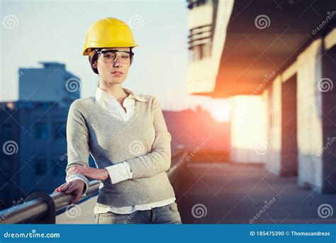 A Beautiful Young Woman Engineer Is In Front Of A Construction Metal