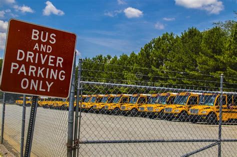 Bus And Driver Parking Only Sign And School Buses Parked Behind A Chain