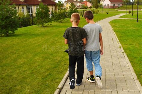 Two Friend Boys Go Along The Path In The Summer Stock Image Image Of