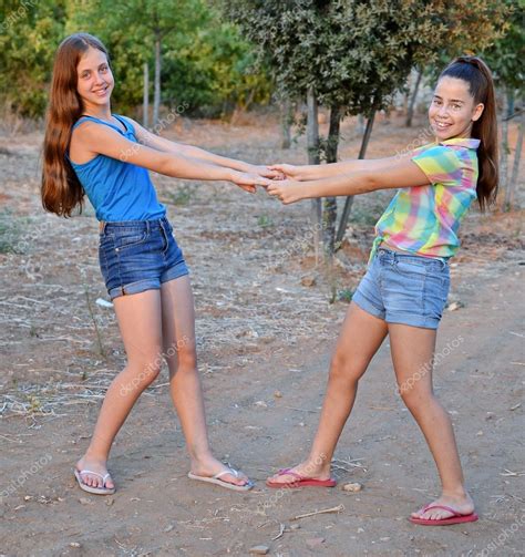 Two Best Friend Girls Holding Hands — Stock Photo © Dnaveh