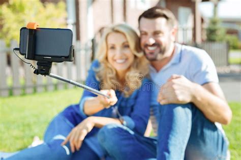 Cheerful Couple Taking Selfies With A Selfie Stick Stock Image Image