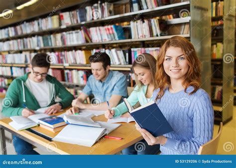Happy Students Reading Books In Library Stock Photo Image Of