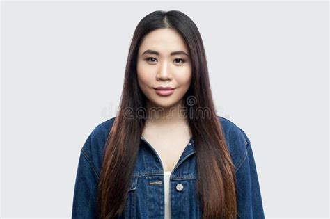 Portrait Of Beautiful Brunette Asian Young Woman In Casual Blue Denim Jacket With Makeup