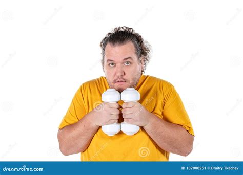 Funny Fat Man Exercising With Dumbbells And Looking At Camera Isolated