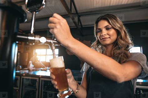 Beautiful Female Bartender Tapping Beer In Bar Stock Photo 127207