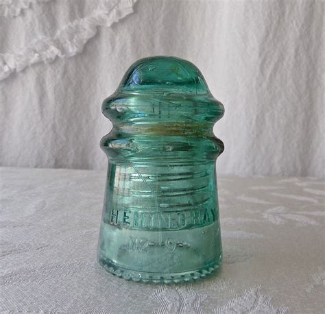 A Green Glass Bottle Sitting On Top Of A Table