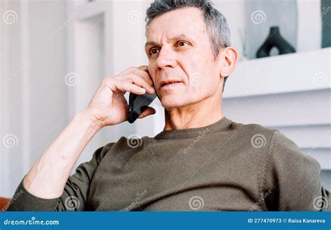 Serious Concerned Old Man Talking On Mobile Phone Calling For