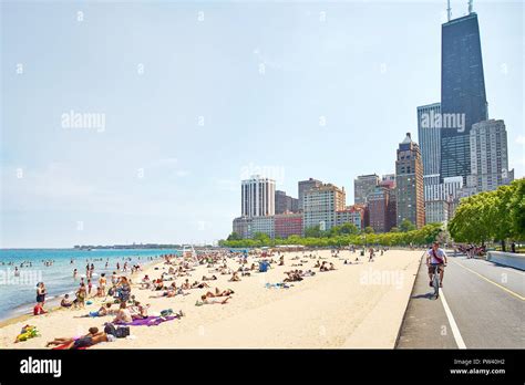 People Enjoying The Water And The Sun At The Oak Street Beach In