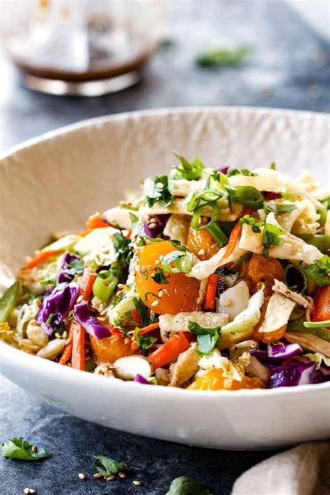 Made with crunchy napa cabbage, crispy ramen noodles and a delicious asian dressing this salad will become a weeknight staple and family favorite. side view of top view of best ever Chinese chicken salad with ramen noodles, Mandarin ora ...