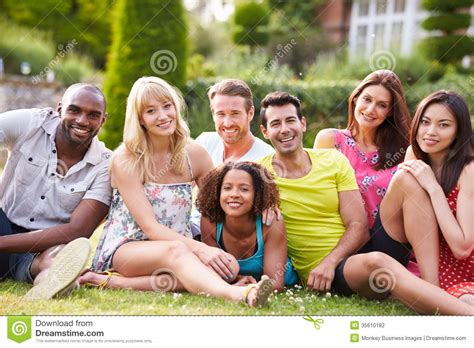 Group Of Friends Sitting On Grass Together Stock Photo Image Of