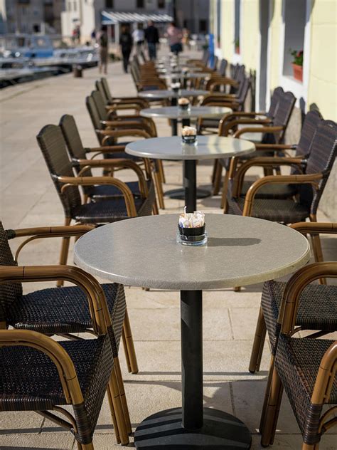 Cafe homestead serves fresh, natural food true to its setting at homestead heritage, a traditional farming community. Empty tables and chairs of a cafe in Cres Photograph by ...