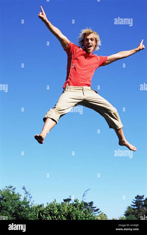 Young Man Jumping Stock Photo Alamy