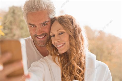 Affectionate Couple Smiling Taking Selfie Outdoors Stock Image F017