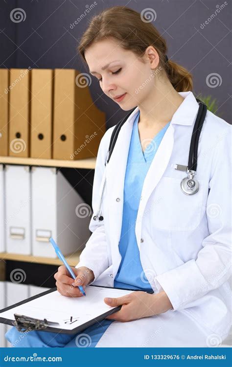 Woman Doctor At Work At Hospital Young Female Physician Write