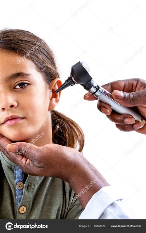 Ent Physician Looking Into Patients Ear With An Otoscope Child