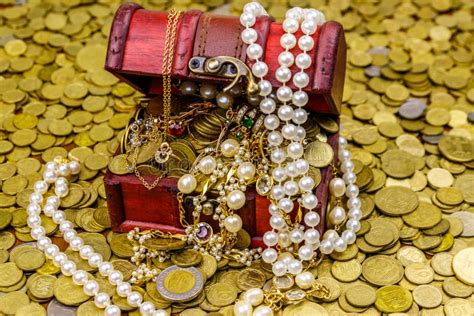 Vintage Treasure Chest Full Of Gold Coins And Jewelry On A Background