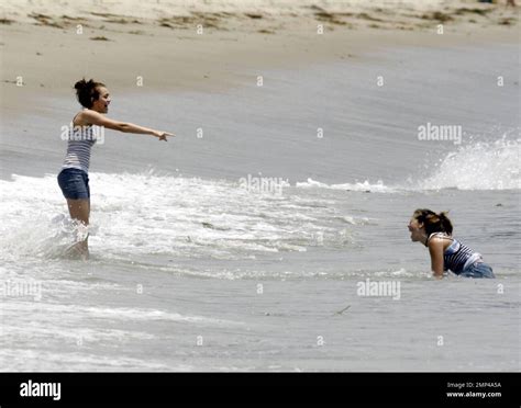 miley cyrus frolics in the surf with friends castmates while filming her latest hannah montana