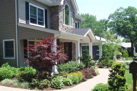 A simple frontal pathway with lush green lawn from both side and a touch of flower bed give a perfect landscaping recipe for the front of your home. New York Landscaping - Massapequa, NY - Photo Gallery ...