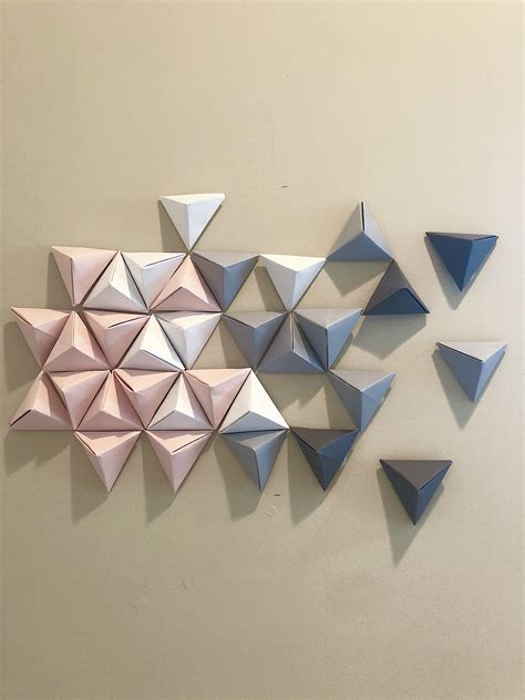 Several Origami Shapes Are Arranged On The Wall