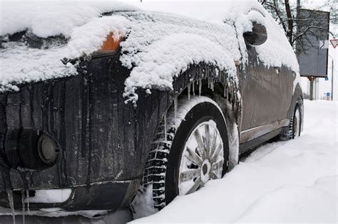 Premium Photo Wheels Of A Dirty Black Car In Deep Snow Tires Are