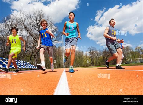 Athletics Teenage Boys Running On The Racetrack Stock Photo Alamy