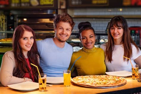 Cheerful Multiracial Friends Having Fun Eating In Pizzeria Stock Image Image Of Happy