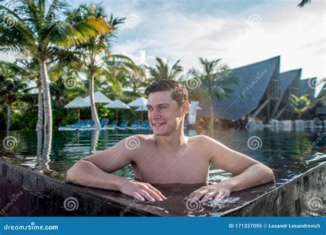 Portrait Of Young Smiling Handsome Man At Tropical Island Luxury Resort