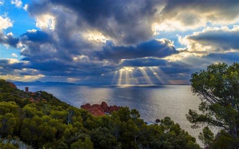 Nature Landscape Sky Clouds Sun Rays Trees Shrubs Sea Rock Mountain Water Wallpapers