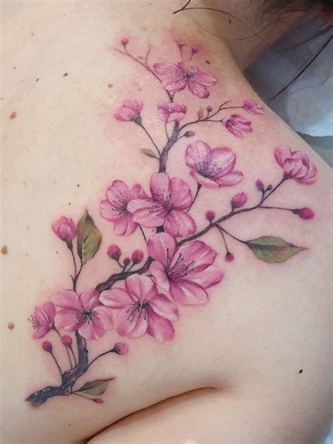 a woman s breast with pink flowers on it