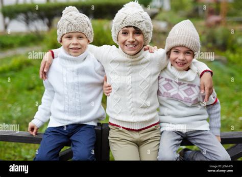 Three Happy Boys Playing Outdoors In Countryside Posing To Camera